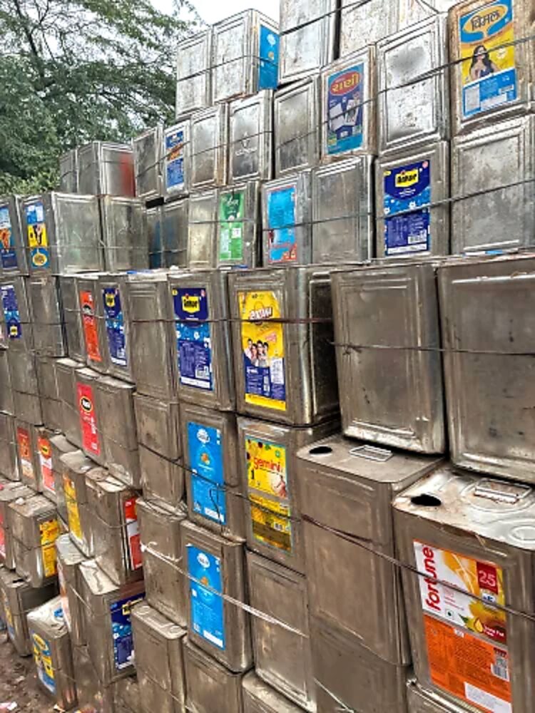 Stacked scrap tin containers
